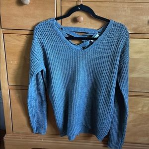 cute grey sweater crisis cross in back
